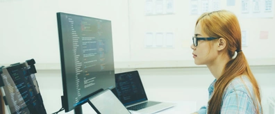 Database engineers reviewing schema design on a wall display