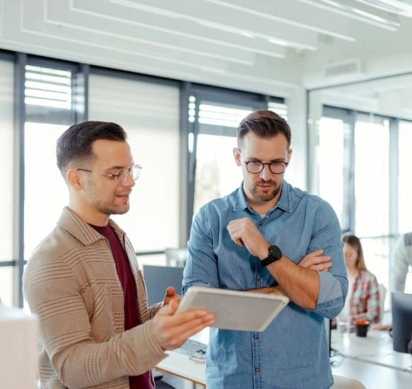 Enterprise software architects reviewing a cloud architecture blueprint