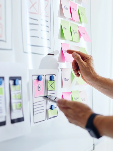 Designers reviewing mobile app UI screens